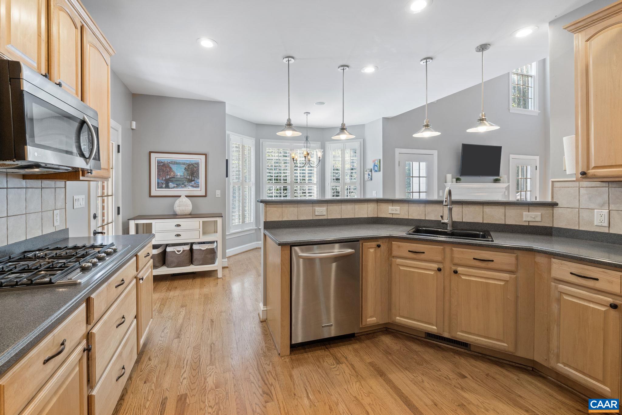 2370 Walnut Ridge Lane Charlottesville, VA 22911 - Photo 12 of 61 a kitchen with stainless steel appliances granite countertop a stove a sink dishwasher a refrigerator and white cabinets with wooden floor