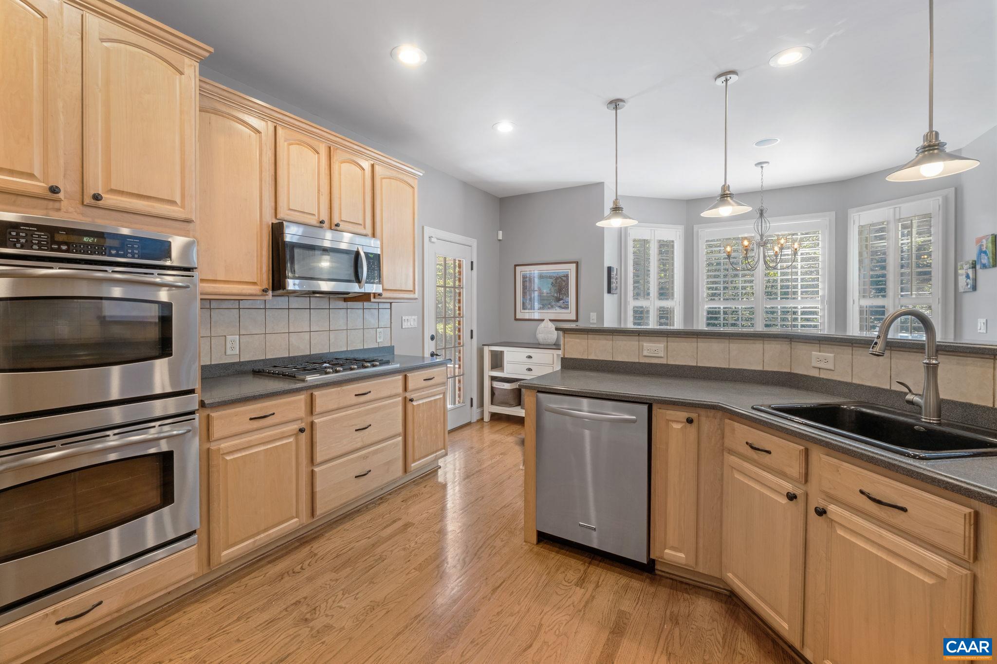 2370 Walnut Ridge Lane Charlottesville, VA 22911 - Photo 13 of 61 a kitchen with stainless steel appliances granite countertop a sink a stove and a wooden floors