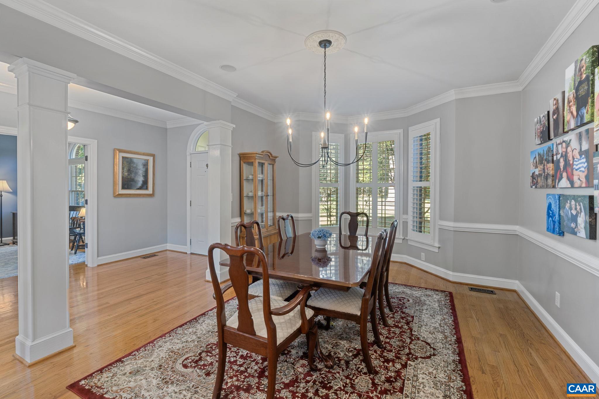 2370 Walnut Ridge Lane Charlottesville, VA 22911 - Photo 18 of 61 a view of a dining room with furniture wooden floor and chandelier
