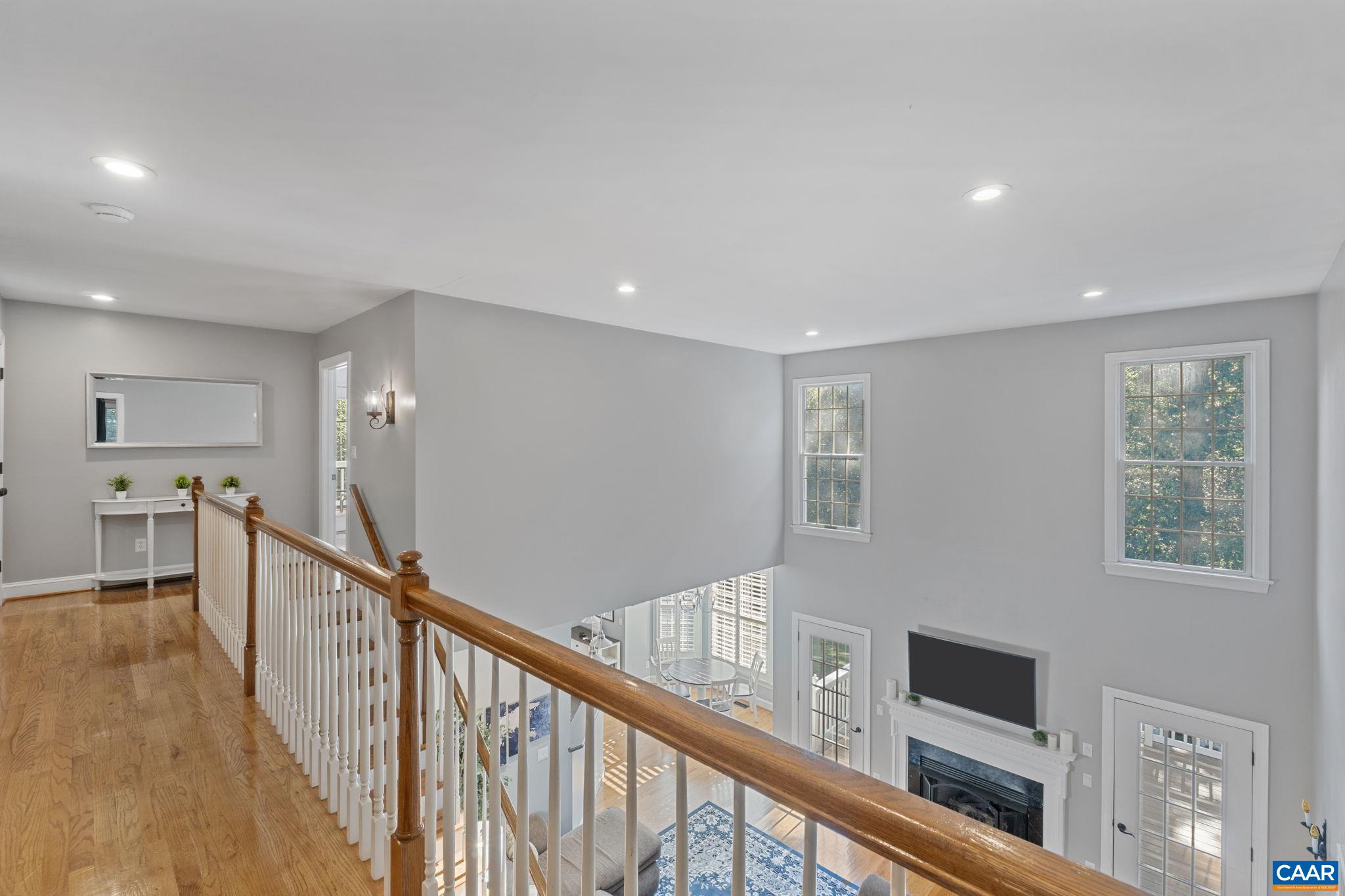 2370 Walnut Ridge Lane Charlottesville, VA 22911 - Photo 22 of 61 a view of a hallway with wooden floor and staircase