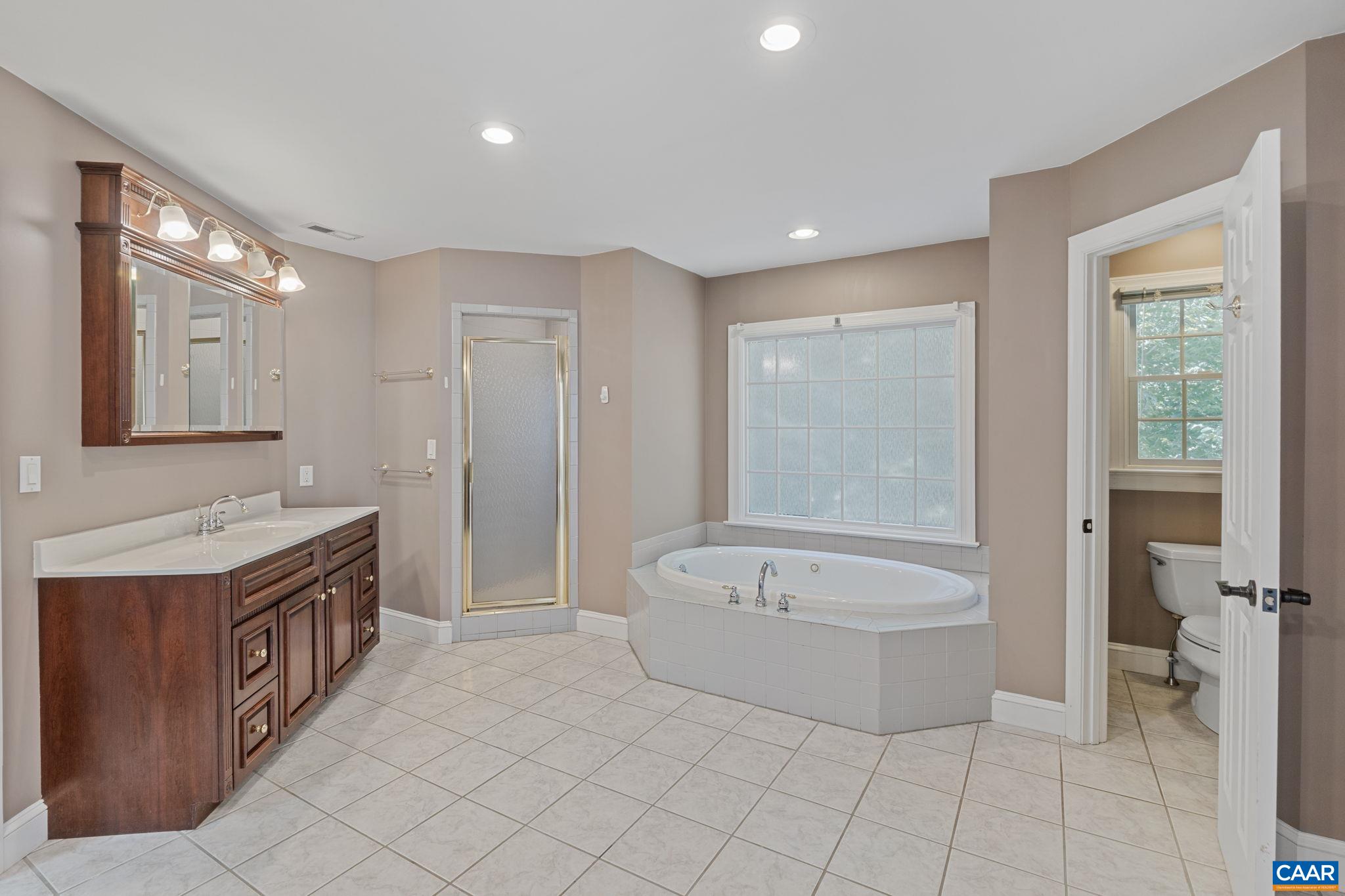 2370 Walnut Ridge Lane Charlottesville, VA 22911 - Photo 26 of 61 a spacious bathroom with a tub sink and mirror