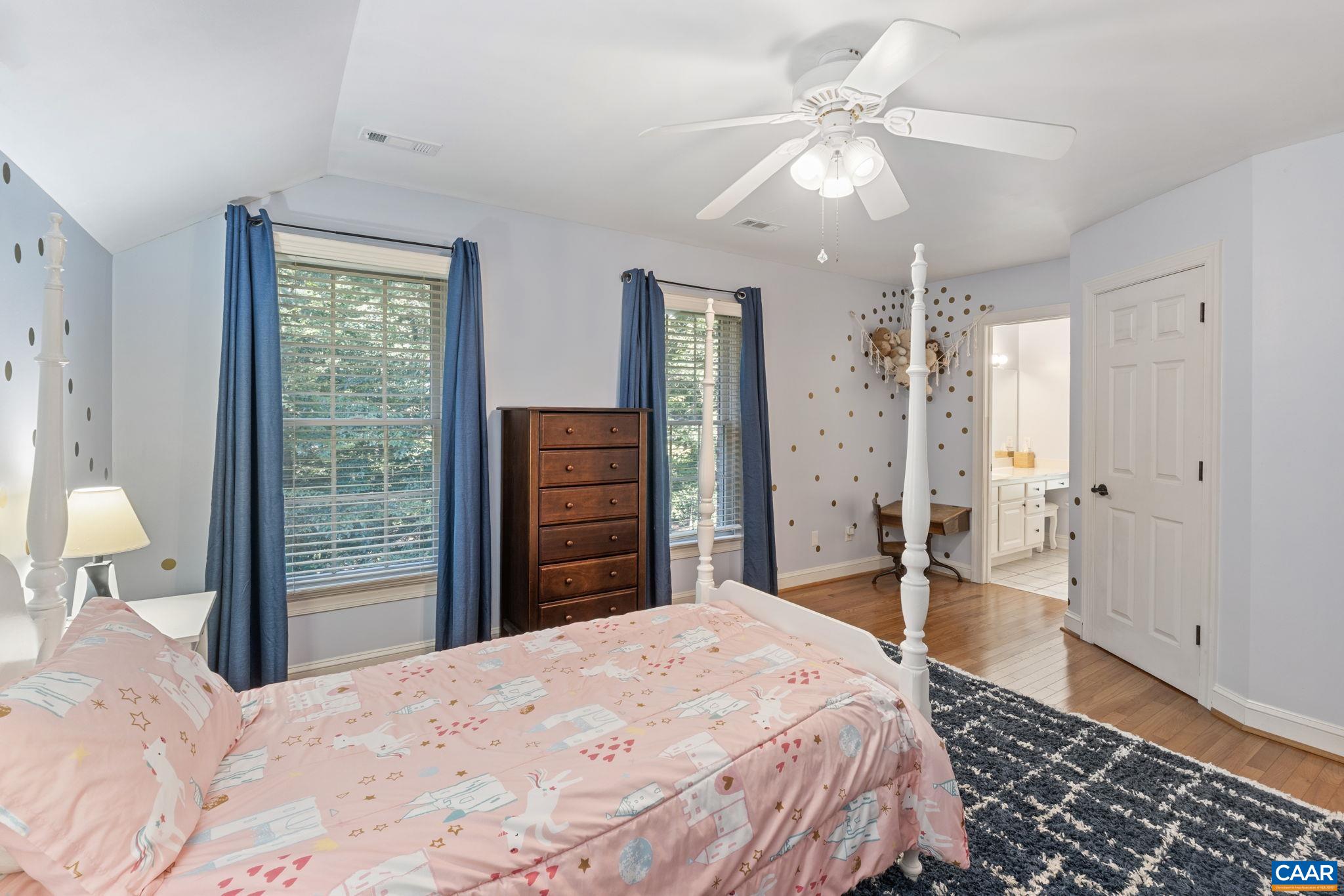 2370 Walnut Ridge Lane Charlottesville, VA 22911 - Photo 32 of 61 a bedroom with a bed and a chandelier