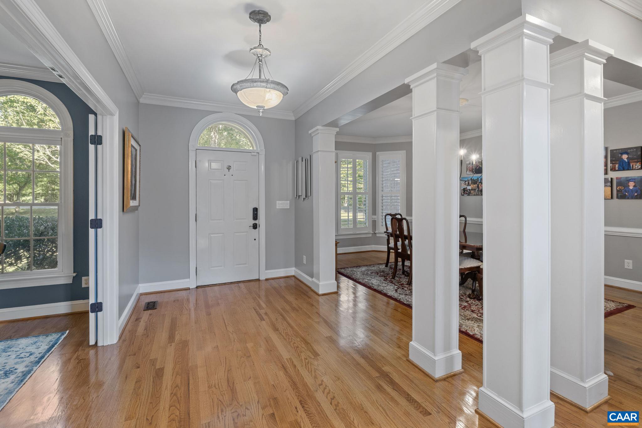 2370 Walnut Ridge Lane Charlottesville, VA 22911 - Photo 5 of 61 a view of a hallway with wooden floor and windows