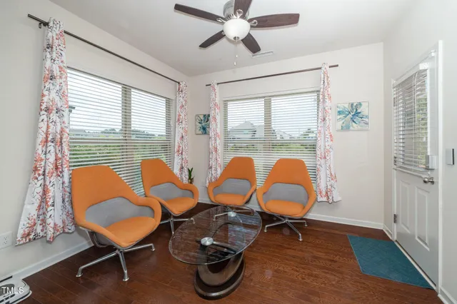 a room with chairs and wooden floor