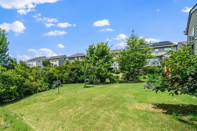 a backyard of a house with lots of green space and garden