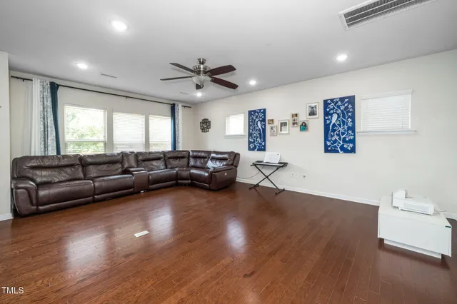 a living room with furniture or wooden floor and a window
