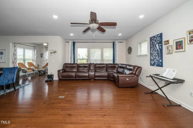 a living room with furniture and a wooden floor