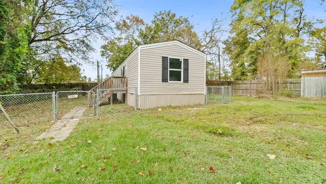 a backyard of a house with table and chairs