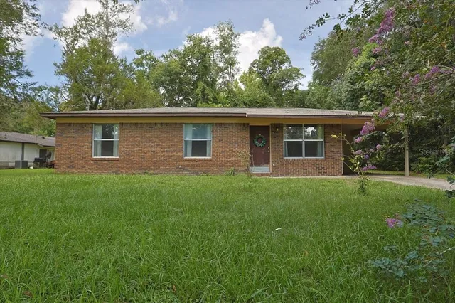 a front view of house with yard and green space