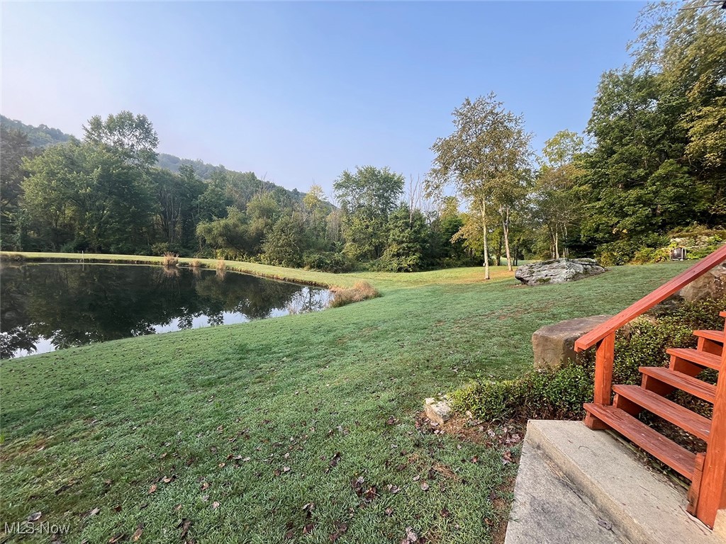 68477 Geese Road Cambridge, OH 43725 - Photo 8 of 32 View of green lawn featuring a water view and a forest view