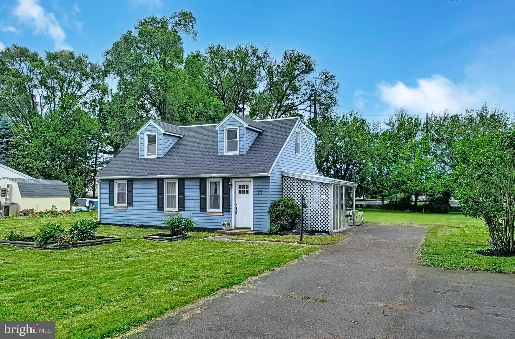 35 West Main Street Salunga, PA 17538 - Photo 1 of 14 Charming blue home with lush greenery.