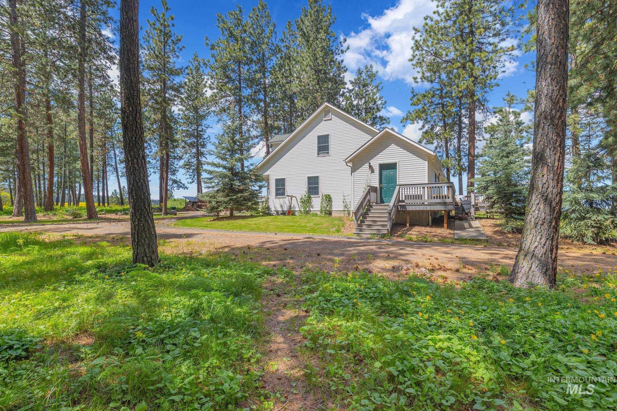 1820 Winchester Road Winchester, ID 83555 - Photo 38 of 50 White exterior with a dark green entry door, wooden deck, and wooden stairs