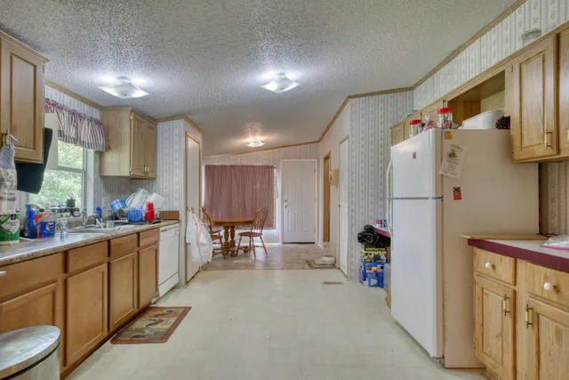 a kitchen view with refrigerator and window