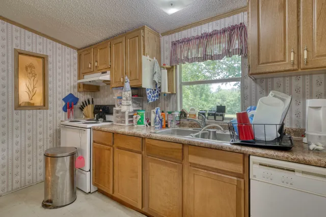 a kitchen with a sink cabinets and window