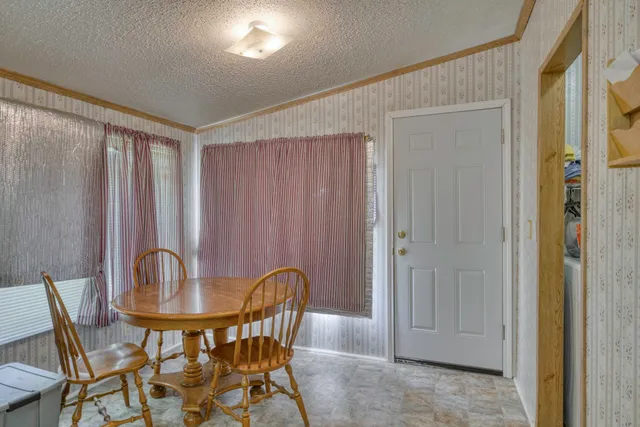 a view of a dining room with furniture and window