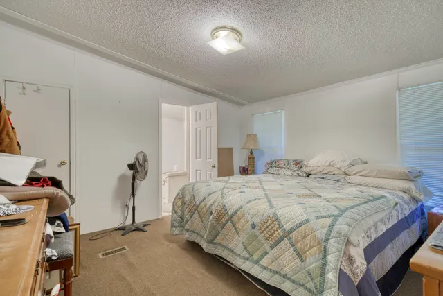 a bedroom with a bed and a mirror