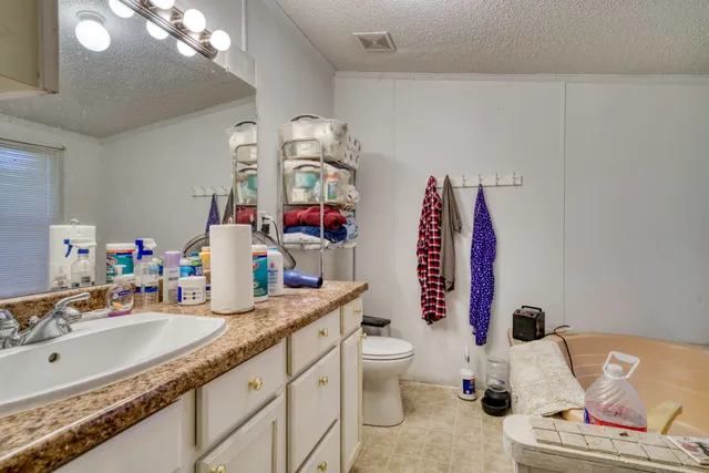 a bathroom with a sink toilet and mirror