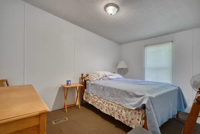 a bedroom with a bed and a table in it