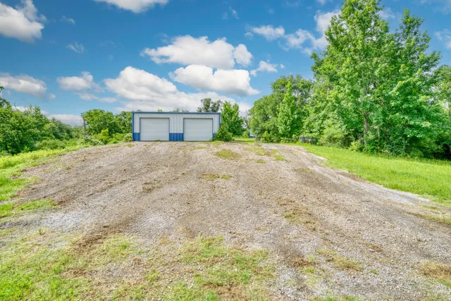 a view of a house with a yard and garage