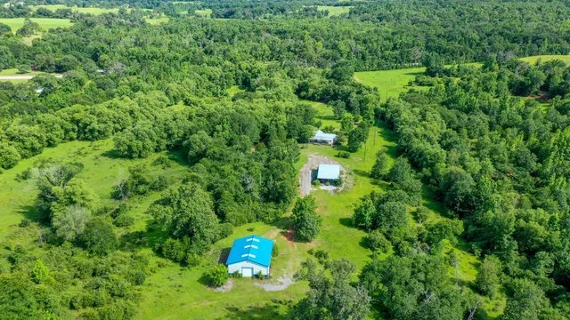 an aerial view of a house with a yard