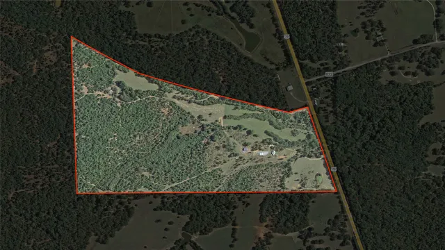 an aerial view of a houses with a yard