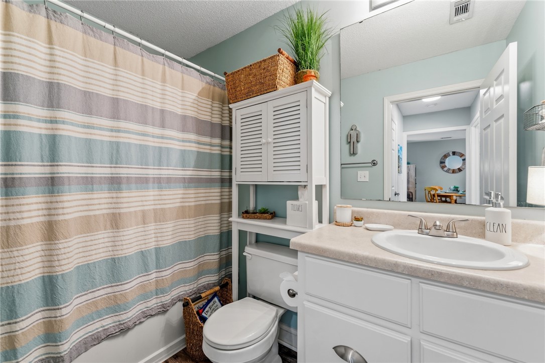 102 Lookover Drive Anderson, SC 29621 - Photo 11 of 27 The bathroom features a contemporary vanity with ample storage, a clean toilet, and a tiled shower.