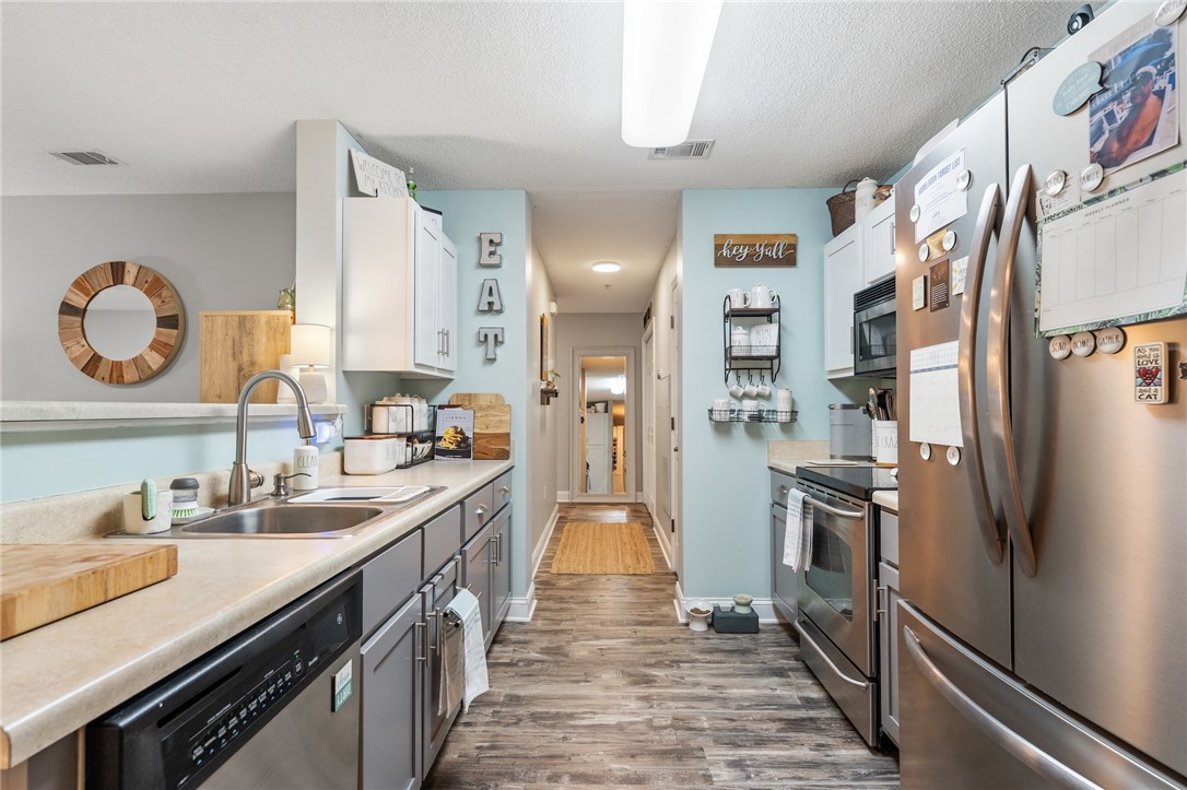 102 Lookover Drive Anderson, SC 29621 - Photo 4 of 27 A galley kitchen features contemporary appliances, ideal for everyday living.