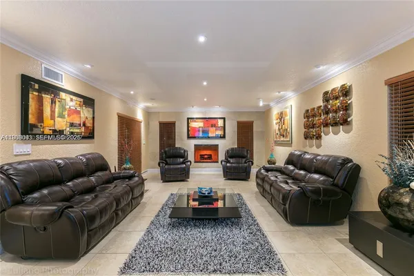 a living room with furniture a rug and a flat screen tv