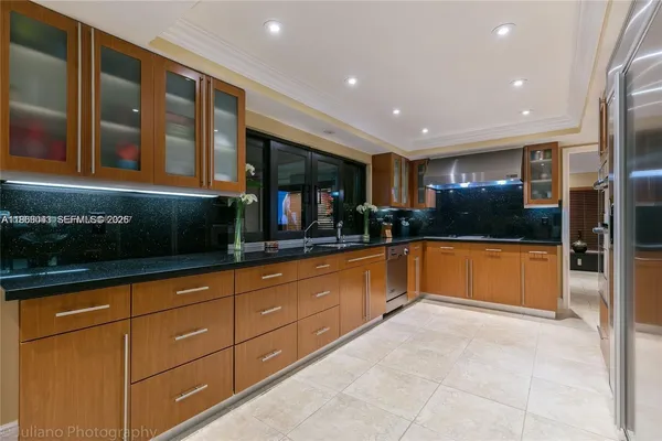 a kitchen with stainless steel appliances granite countertop a refrigerator and a sink