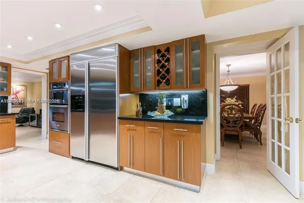a kitchen with kitchen island a counter top space a sink and cabinets