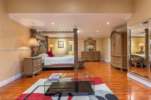 a bedroom with furniture and wooden floor