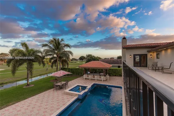 a view of a patio with swimming pool and furniture