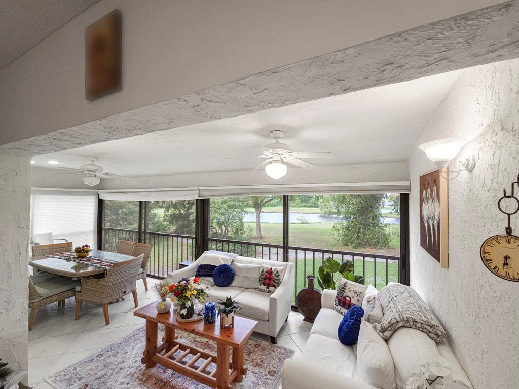 9286 Vista Del Lago, Unit 35B Boca Raton, FL 33428 - Photo 2 of 17 a living room with furniture and a large window