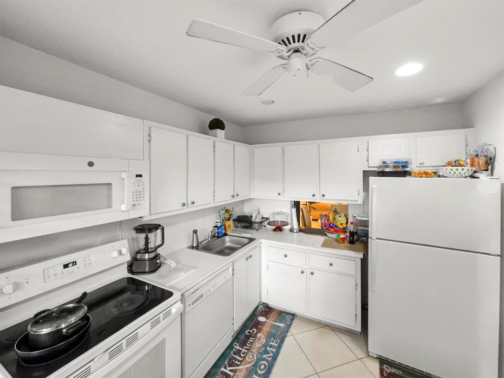 9286 Vista Del Lago, Unit 35B Boca Raton, FL 33428 - Photo 4 of 17 a kitchen with stainless steel appliances a refrigerator sink and cabinets