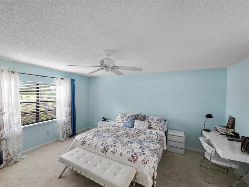 9286 Vista Del Lago, Unit 35B Boca Raton, FL 33428 - Photo 6 of 17 a bedroom with bed and a window