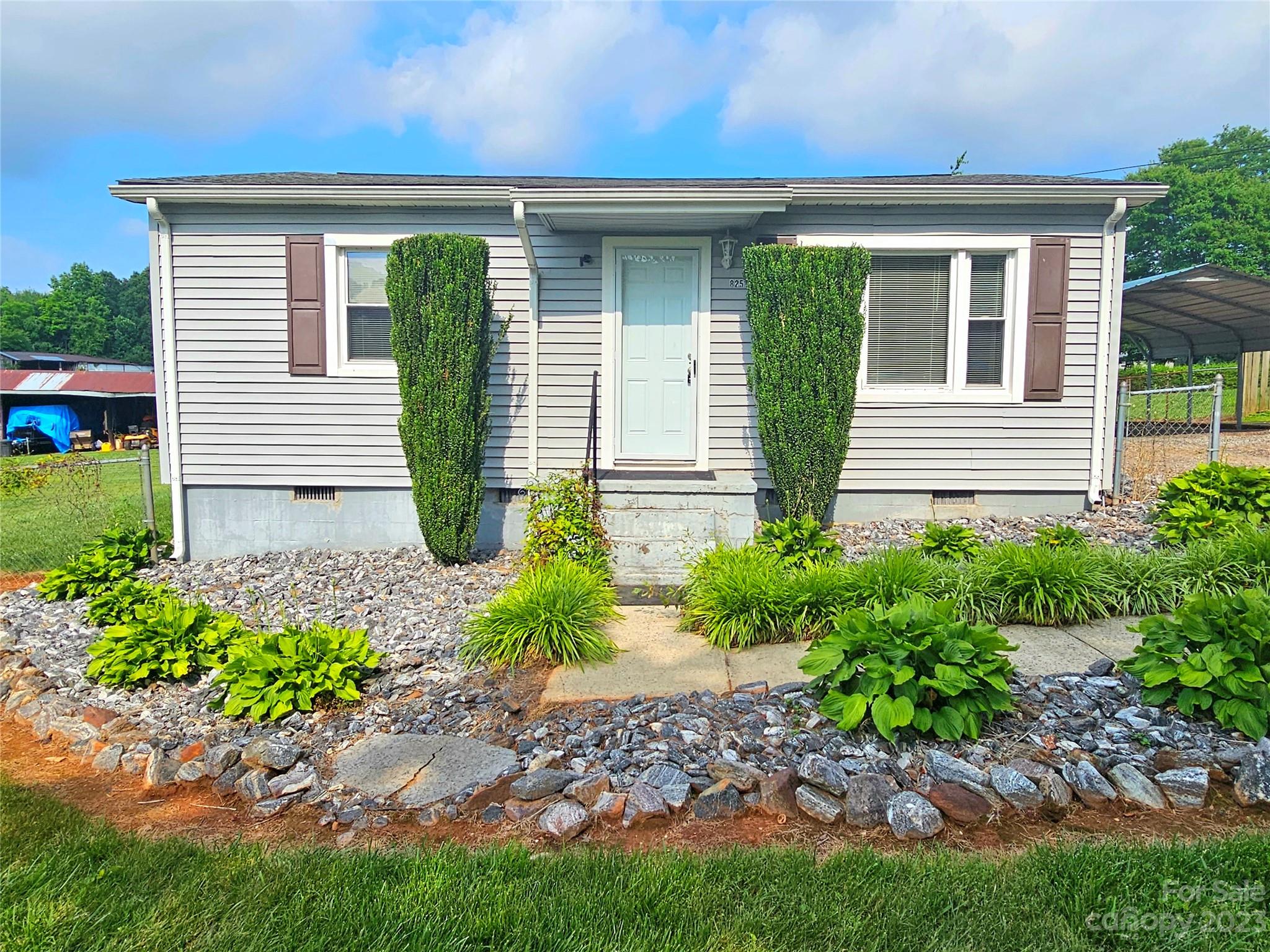 a front view of a house with garden