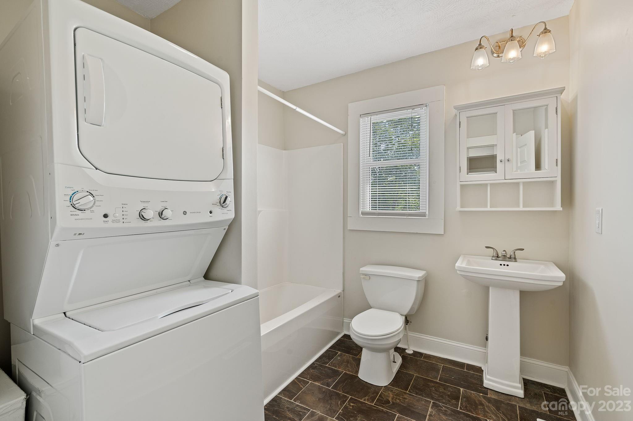 825 Reynolds Road Statesville, NC 28677 - Photo 11 of 26 a white toilet sitting next to a bathroom sink