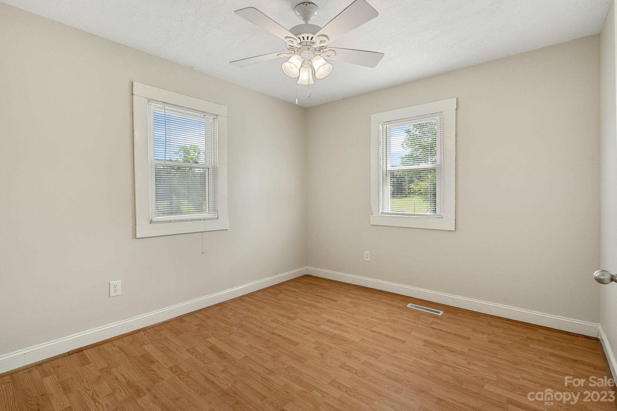 825 Reynolds Road Statesville, NC 28677 - Photo 13 of 26 a view of empty room with wooden floor and fan