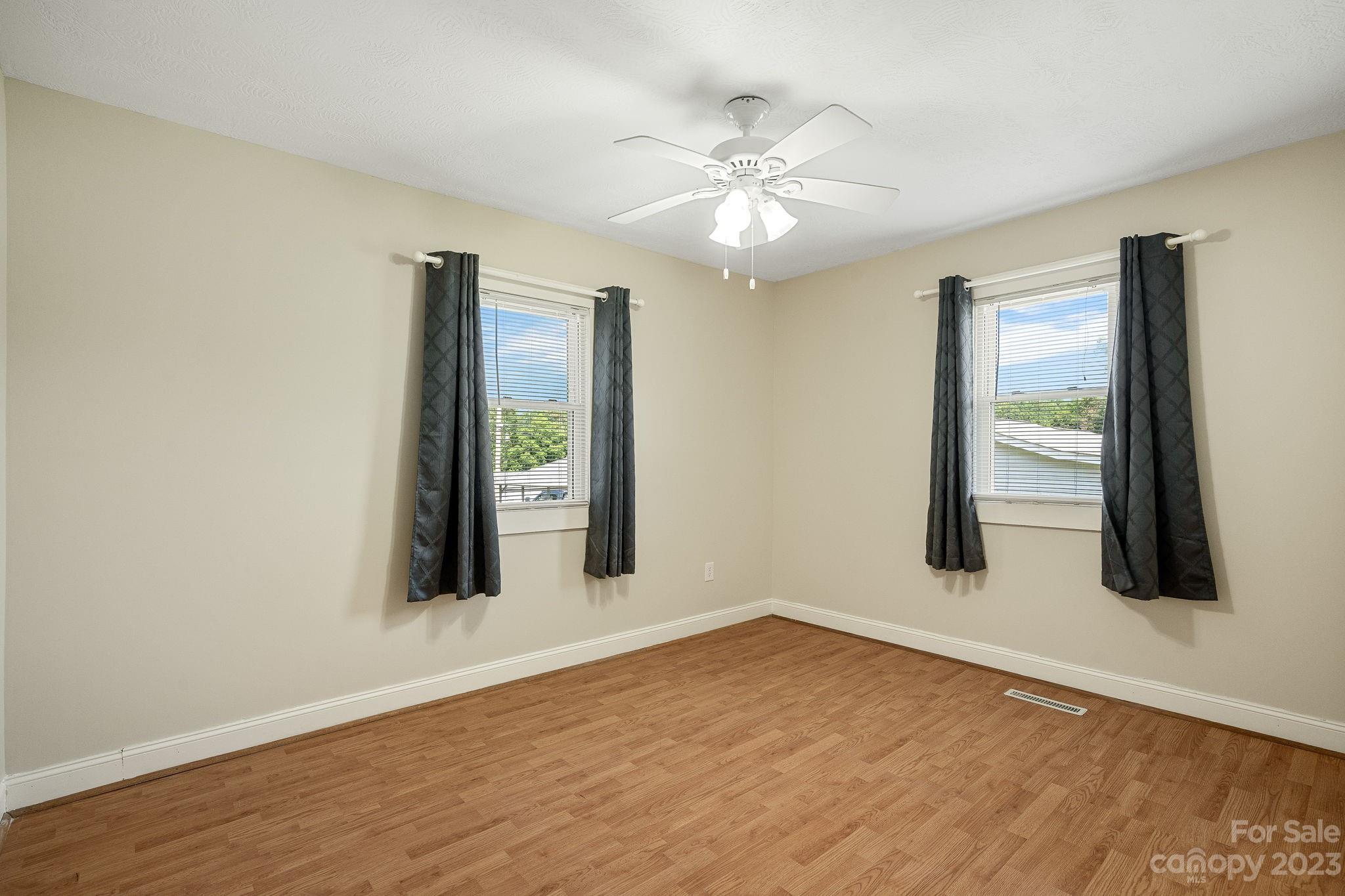 825 Reynolds Road Statesville, NC 28677 - Photo 15 of 26 a view of an empty room with wooden floor and a window