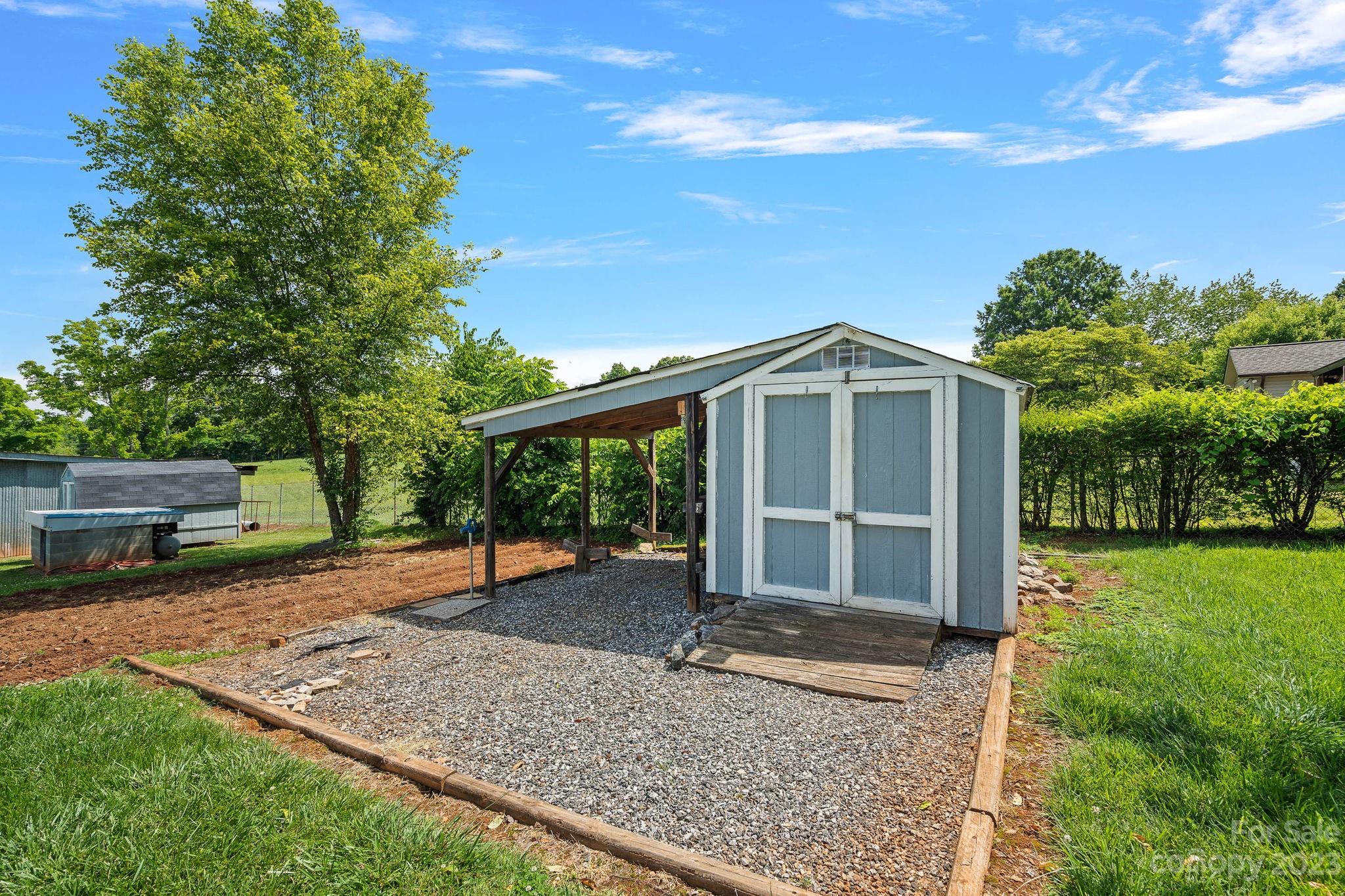 825 Reynolds Road Statesville, NC 28677 - Photo 20 of 26 a view of a house with backyard porch and garden