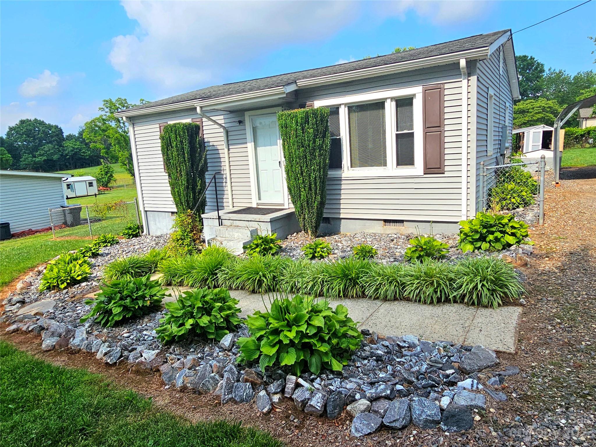 825 Reynolds Road Statesville, NC 28677 - Photo 2 of 26 a view of a house with a garden