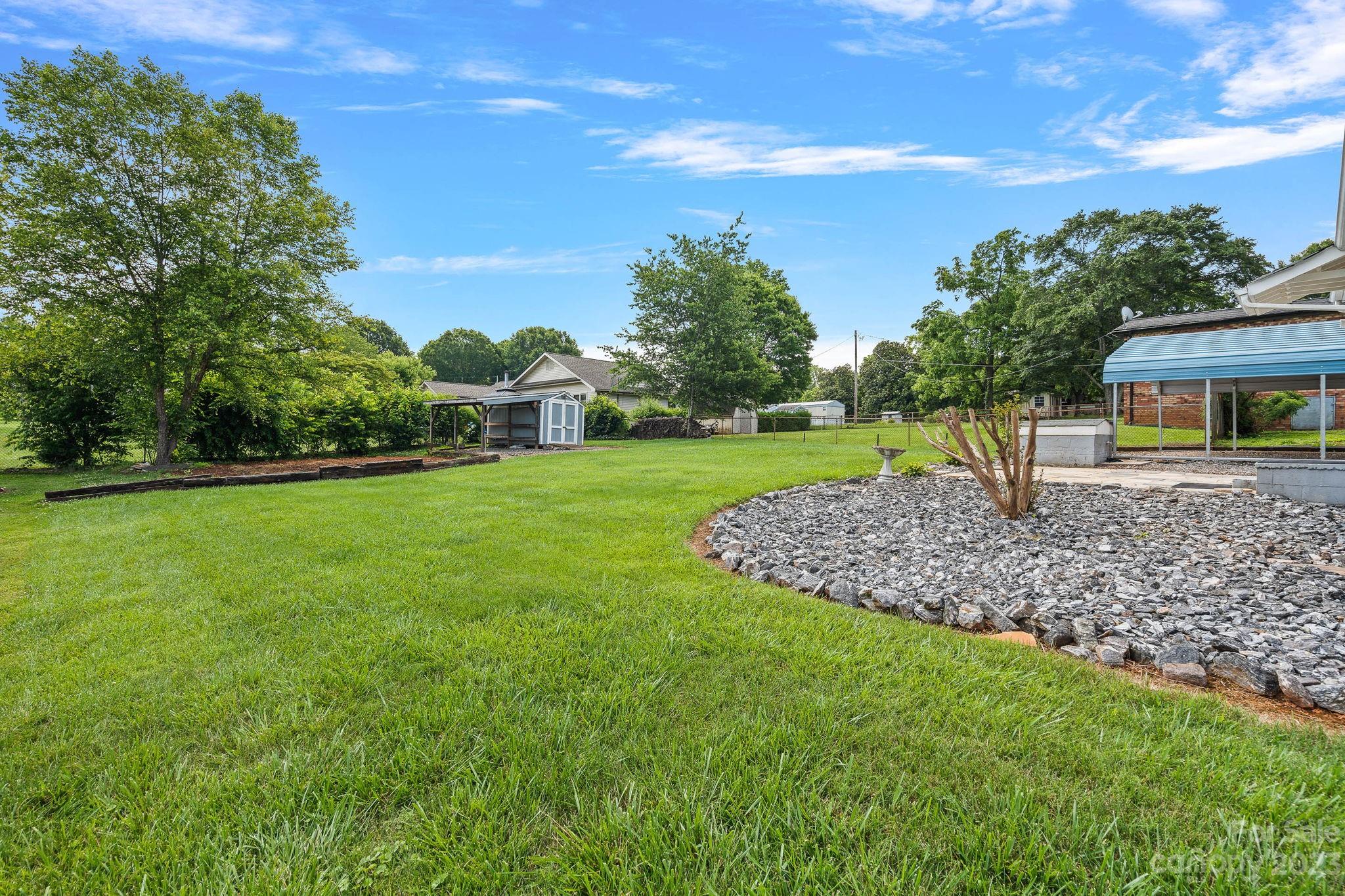 825 Reynolds Road Statesville, NC 28677 - Photo 23 of 26 a view of a garden with a house in the background