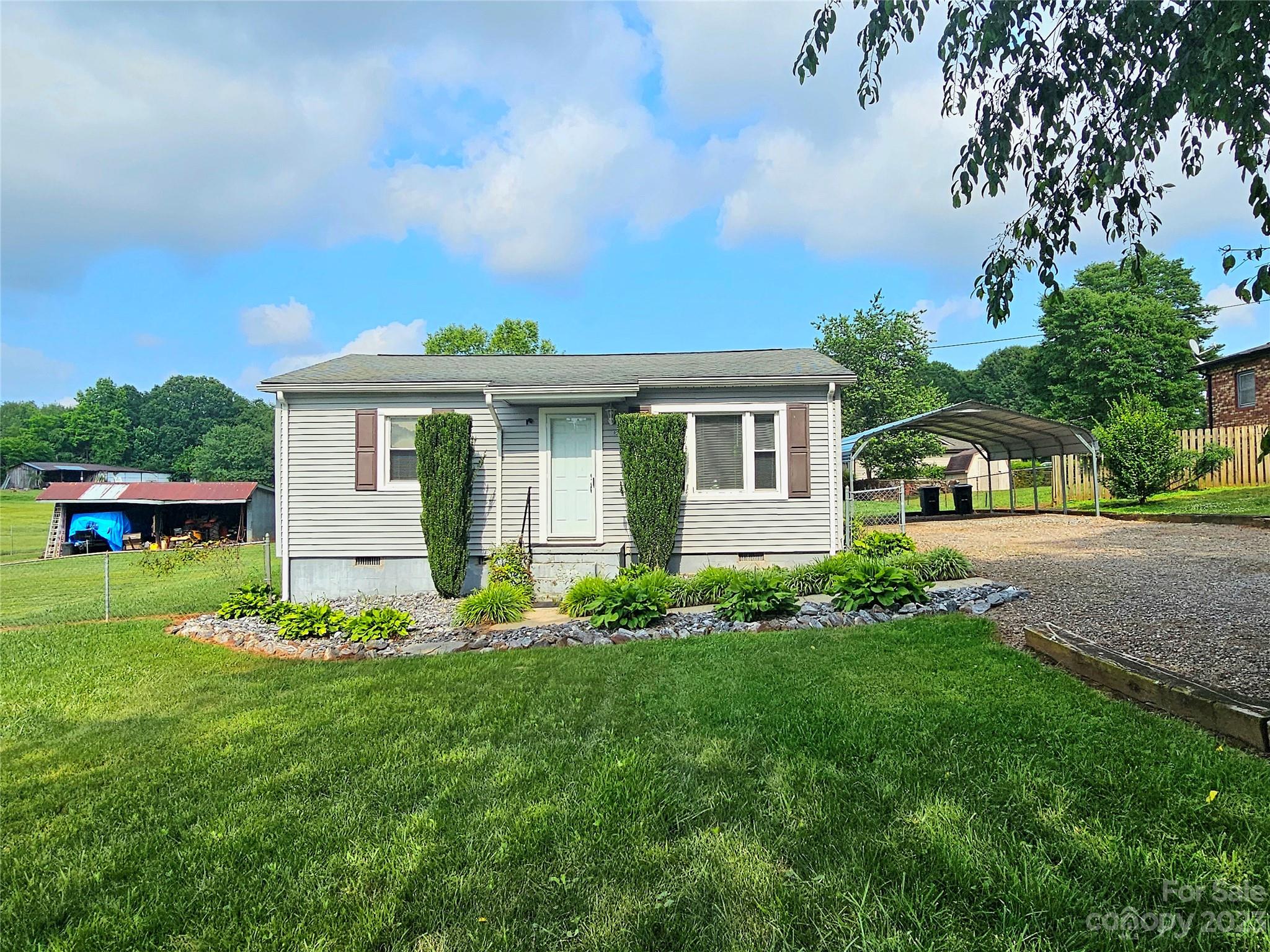825 Reynolds Road Statesville, NC 28677 - Photo 3 of 26 a front view of a house with a yard
