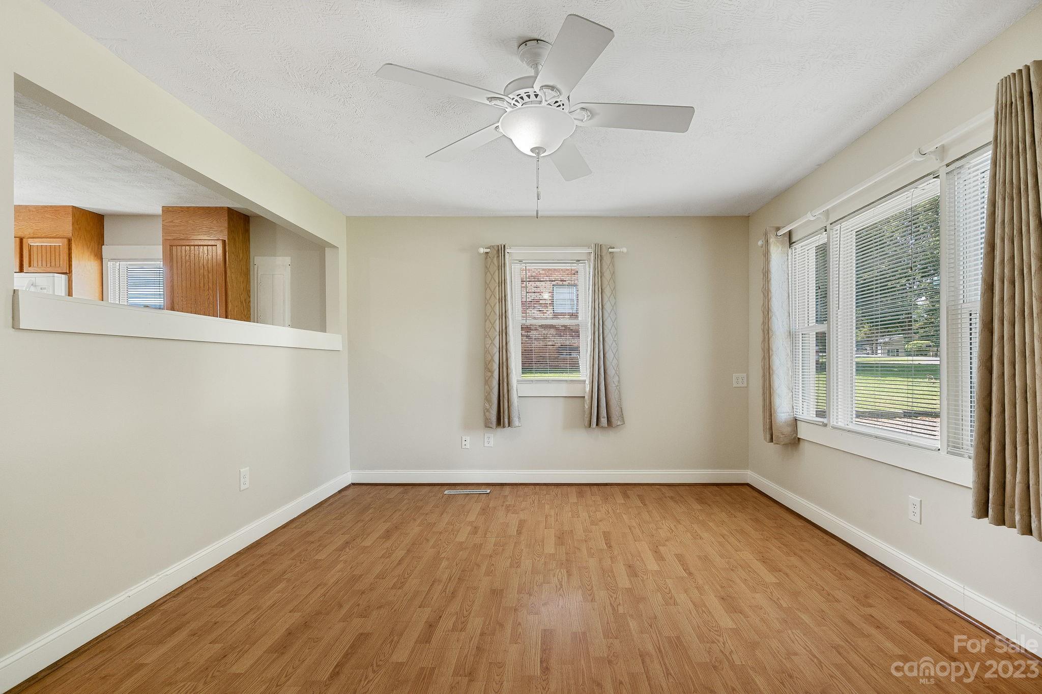 825 Reynolds Road Statesville, NC 28677 - Photo 4 of 26 wooden floor in an empty room with a window