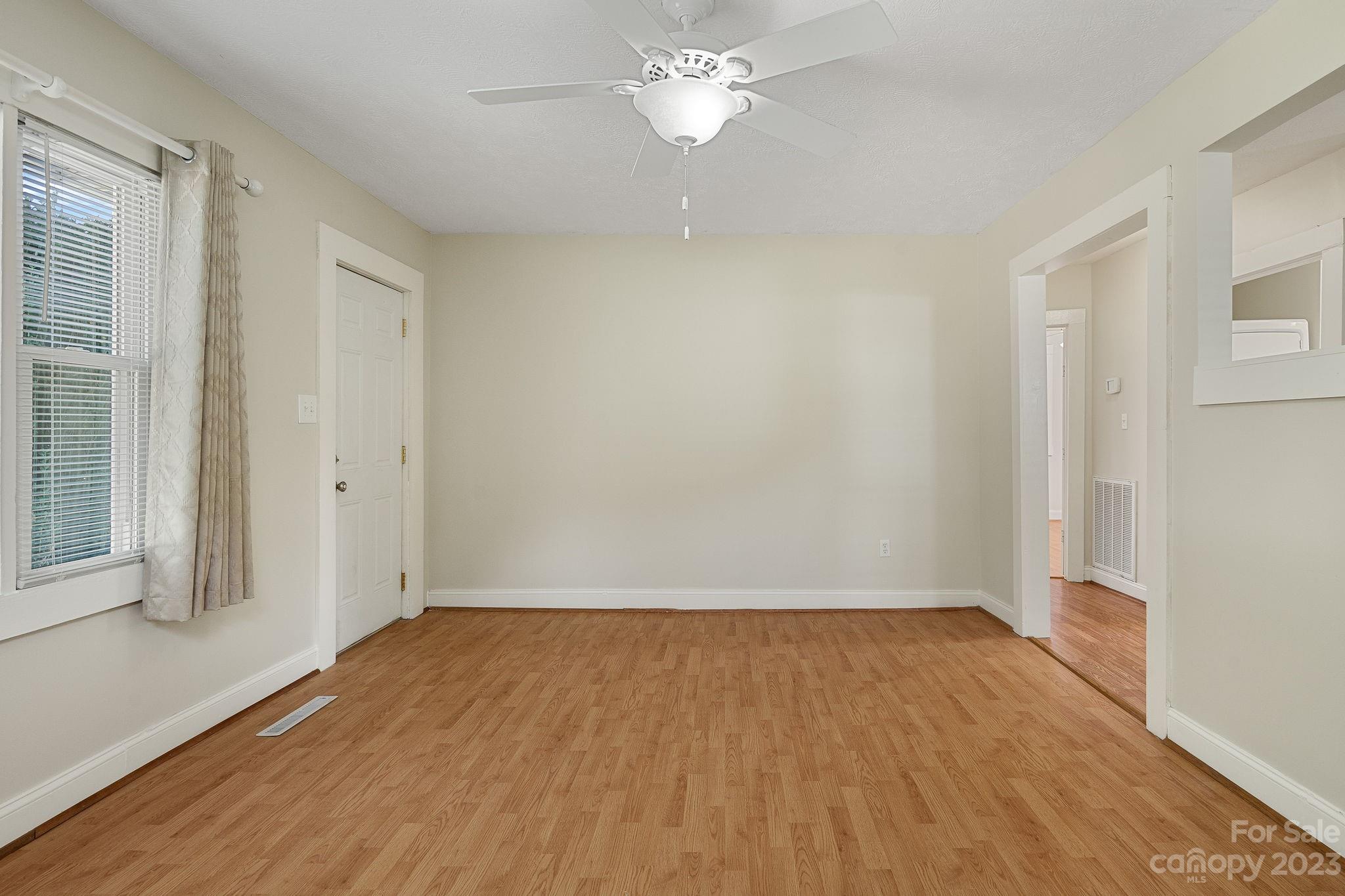 825 Reynolds Road Statesville, NC 28677 - Photo 5 of 26 wooden floor in an empty room with a window