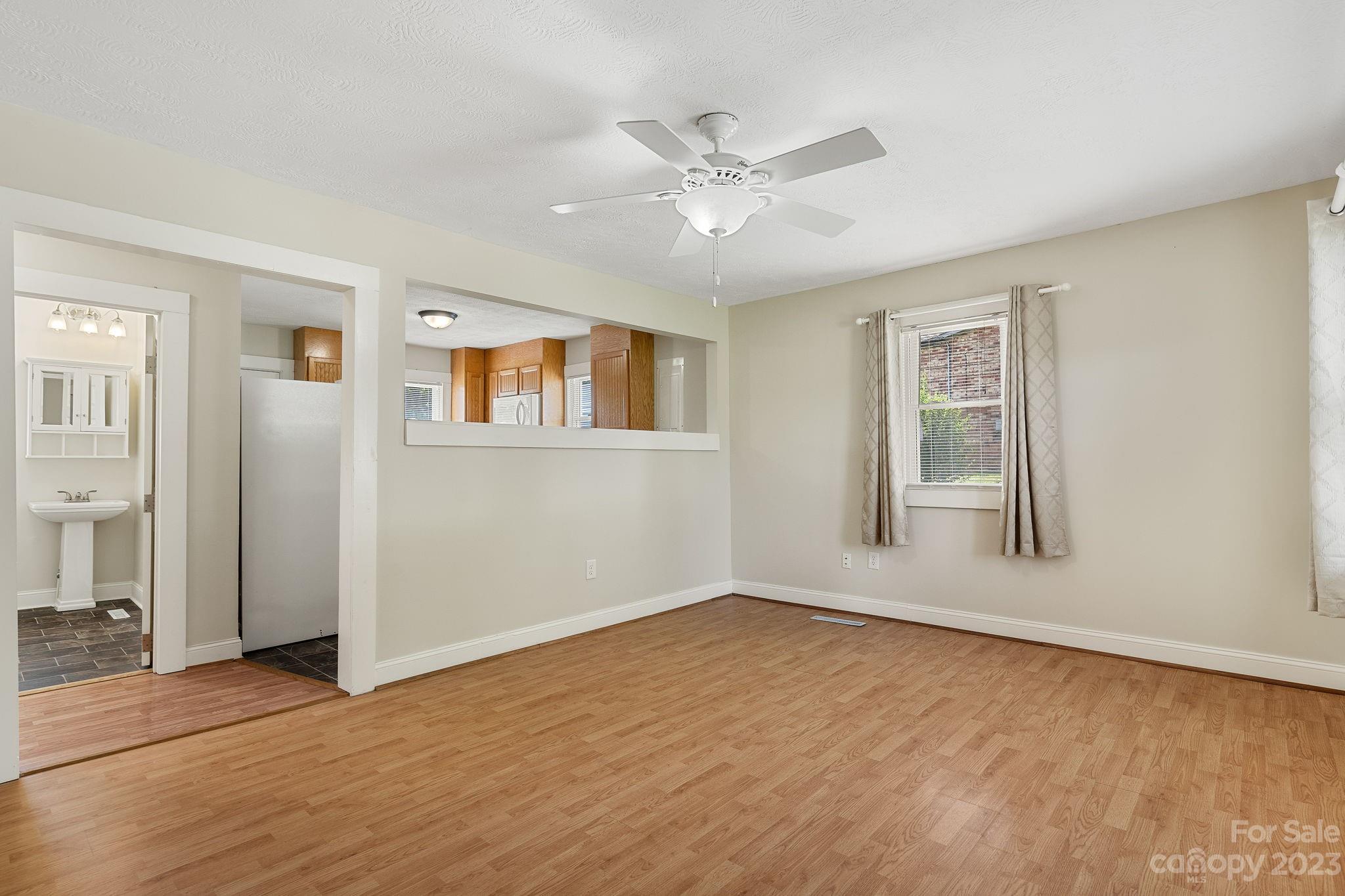 825 Reynolds Road Statesville, NC 28677 - Photo 6 of 26 a view of an empty room with wooden floor and a window
