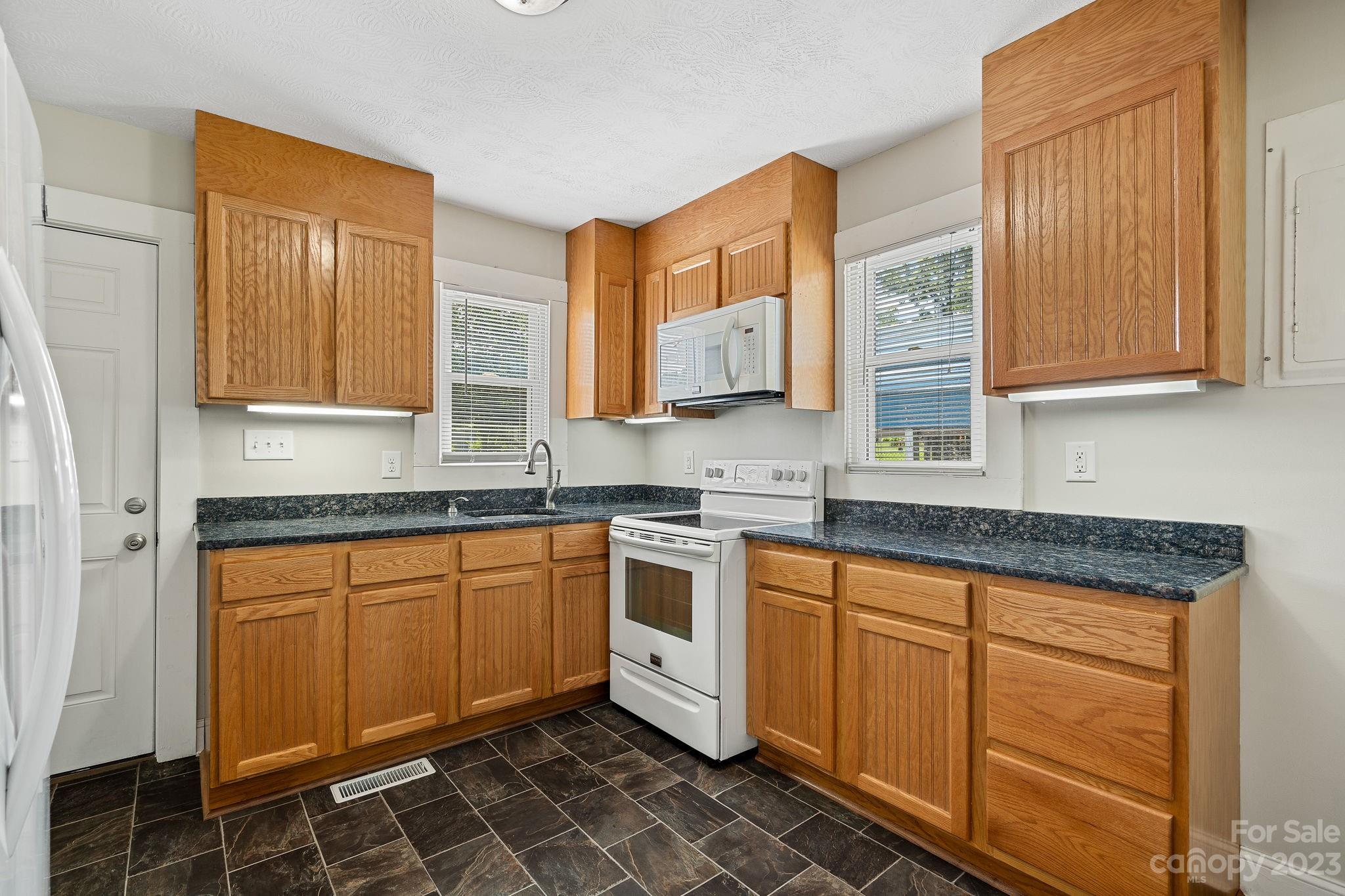 825 Reynolds Road Statesville, NC 28677 - Photo 8 of 26 a kitchen with stainless steel appliances granite countertop a sink and cabinets