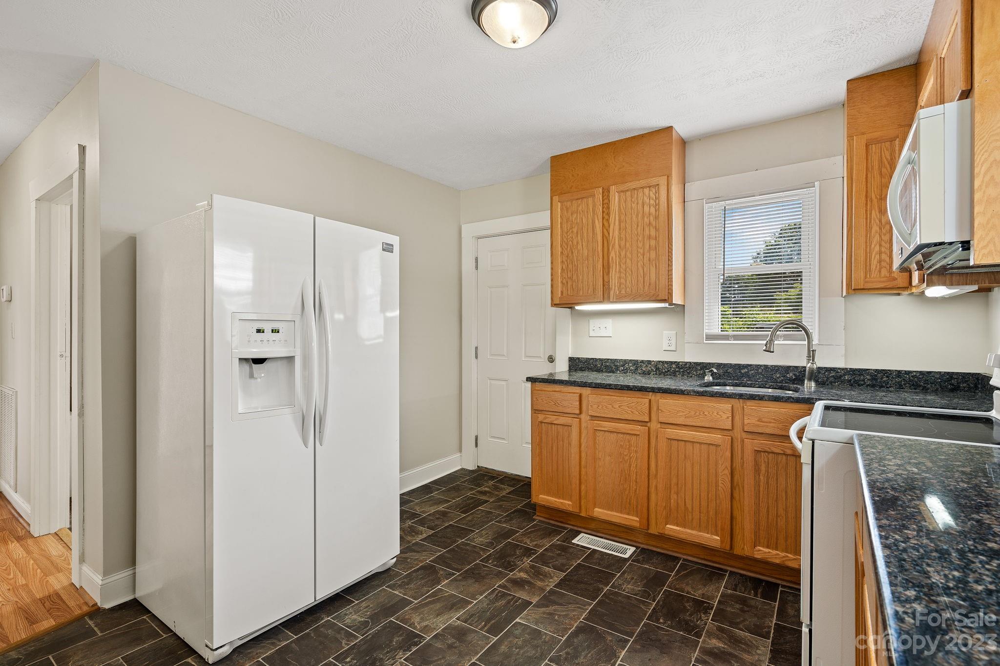 825 Reynolds Road Statesville, NC 28677 - Photo 9 of 26 a bathroom with a granite countertop sink and a mirror