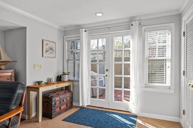 a view of an empty room with furniture and a window