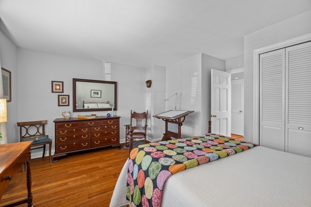 27 R West Street, Unit 4 Beverly, MA 01915 - Photo 20 of 27 a bedroom with a bed and wooden floor